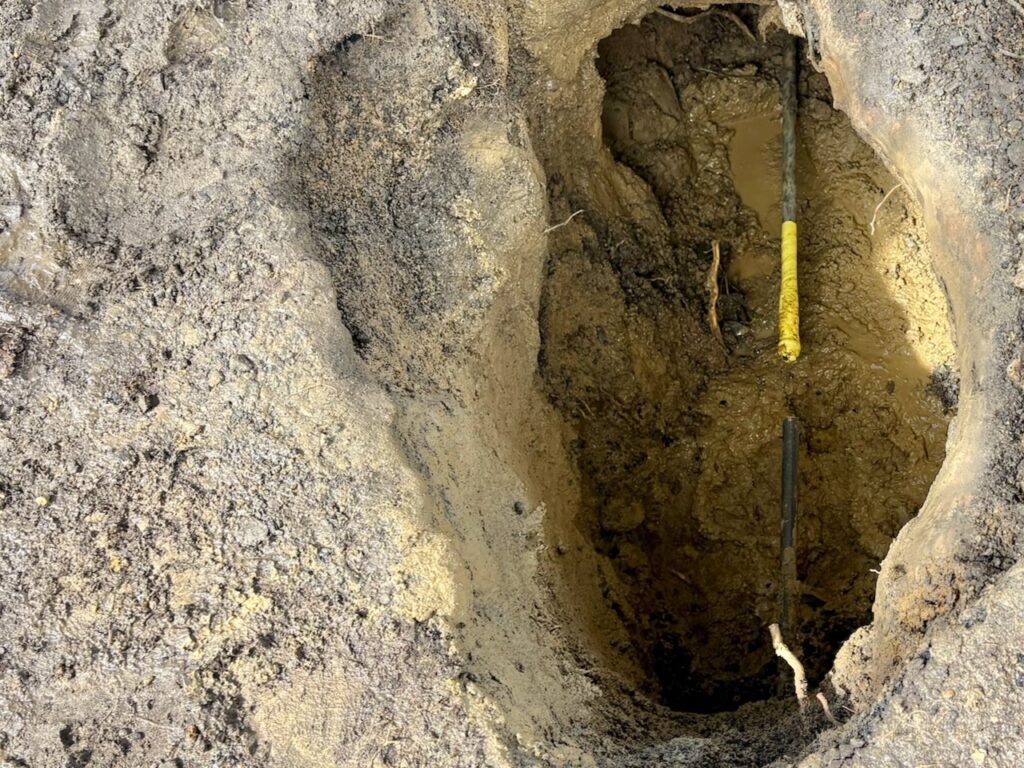 A capped gas line in a deep hole